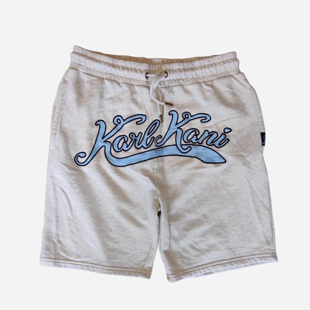 Karl Kani cream shorts with blue cursive 'Karl Kani' logo
